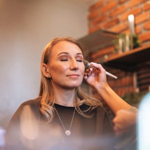 a-female-makeup-artist-applies-makeup-to-young-wom-2024-10-17-04-58-05-utc